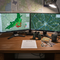 ACI biologist workstation with dual screens showing habitat suitability model and satellite imagery with wildlife corridors